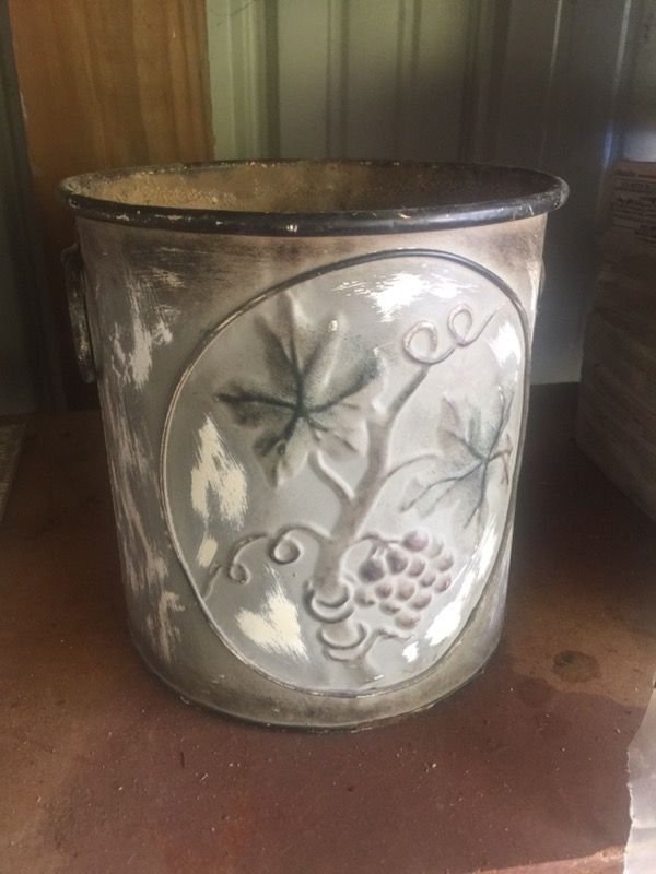 Tuscan style metal plant pot .