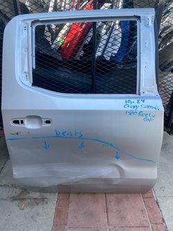 2019–2024 Chevy Silverado 1500 crew cab rear door with visible lower dents.
