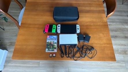Nintendo Switch and two chargers and two games.