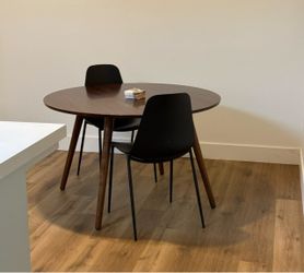 Round Walnut Dining Table with 2 Black Chairs