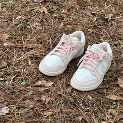 the Nike Dunk Low in the "Orange Pearl" colorway, a women's exclusive style featuring a pastel pink and white design