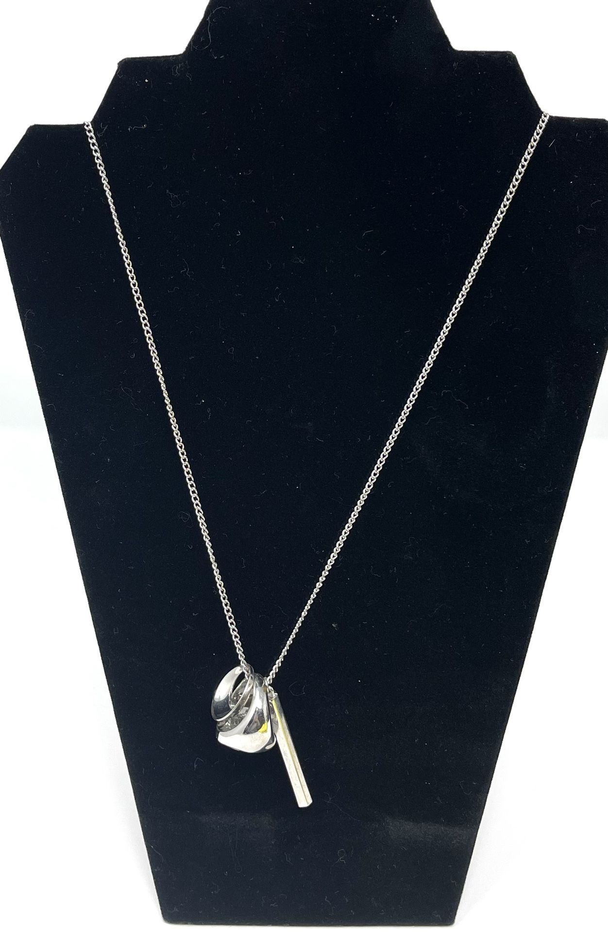 Chicos-  Long Silver tone necklace with 3 ‘charms’. The ring charm is removable & functional about size 7.  33” + 4” extender.