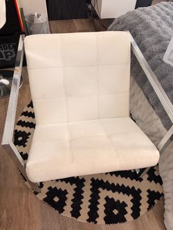 Two white chairs with silver accents