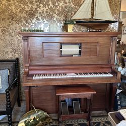 Player Piano With Several Music Rolls.