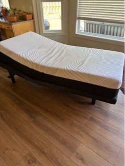 Adjustable single bed with mattress.