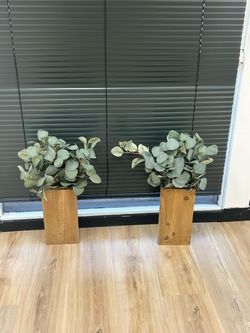 Two wooden planters with faux eucalyptus