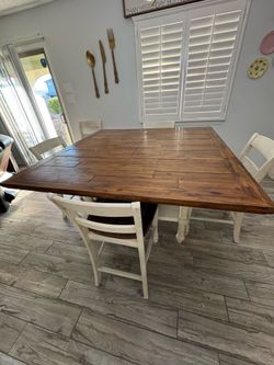 Extendable dining table and 5 chairs with a beautiful dining buffet