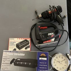 Vintage Alarm Clock, Drill, Saw Cutter, Paper Shredder, Portable Power Inverter, And The Table