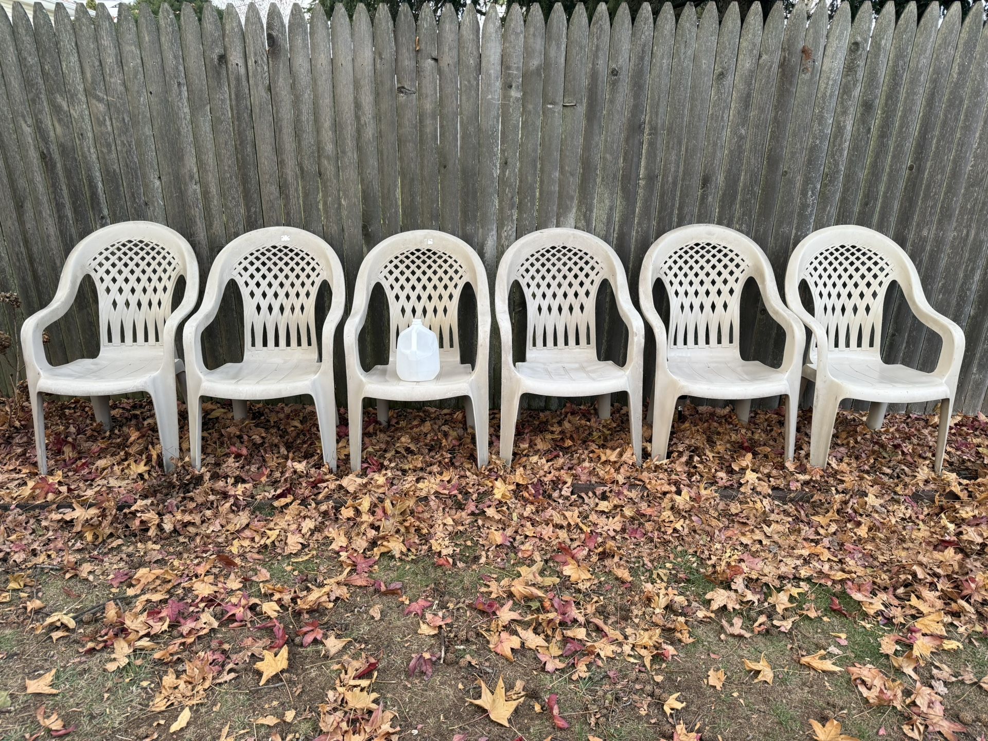 Six large outdoor adult plastic stackable chairs by Syroco