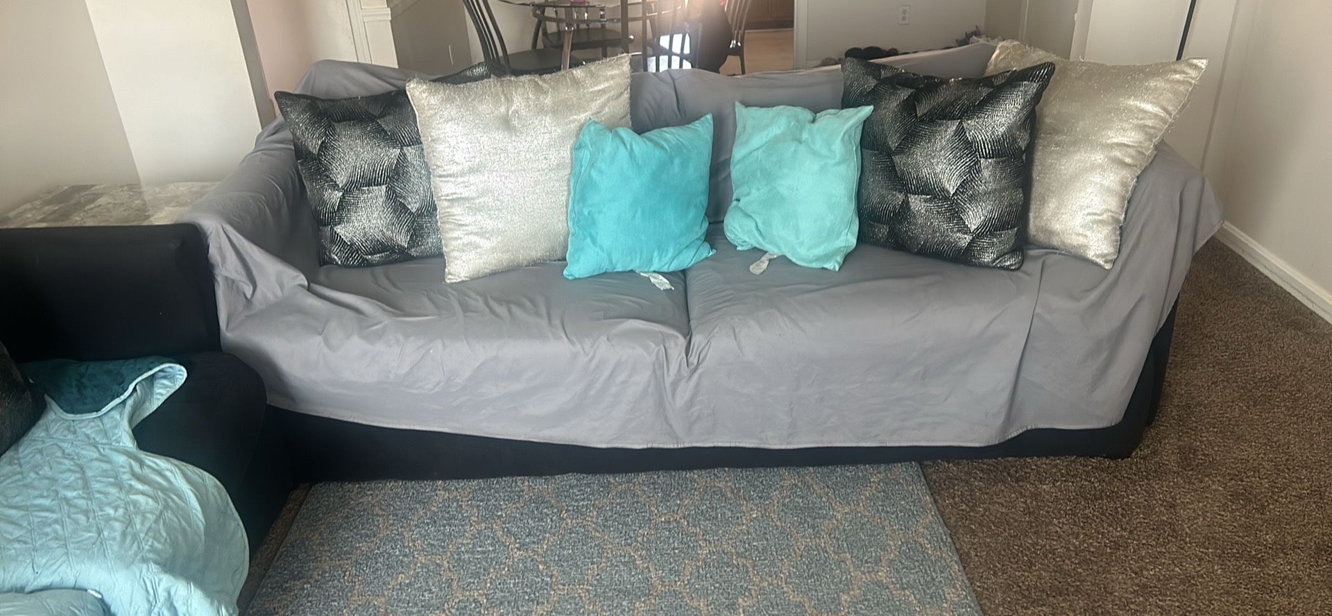 Two black couches and two end tables