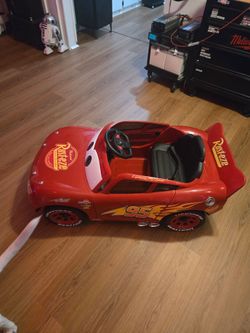 New never used Huffy Cars Lightning McQueen 6V Ride-On Toy Car with Headlights & Engine Sounds, Foot Pedal Drive, Up to 2.5 MPH