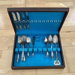 Antique sterling silver-plated silverware in wooden box.