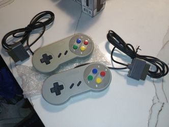 third-party replacement controllers styled after the original Super Nintendo Entertainment System (SNES).They feature the classic gray color scheme wi