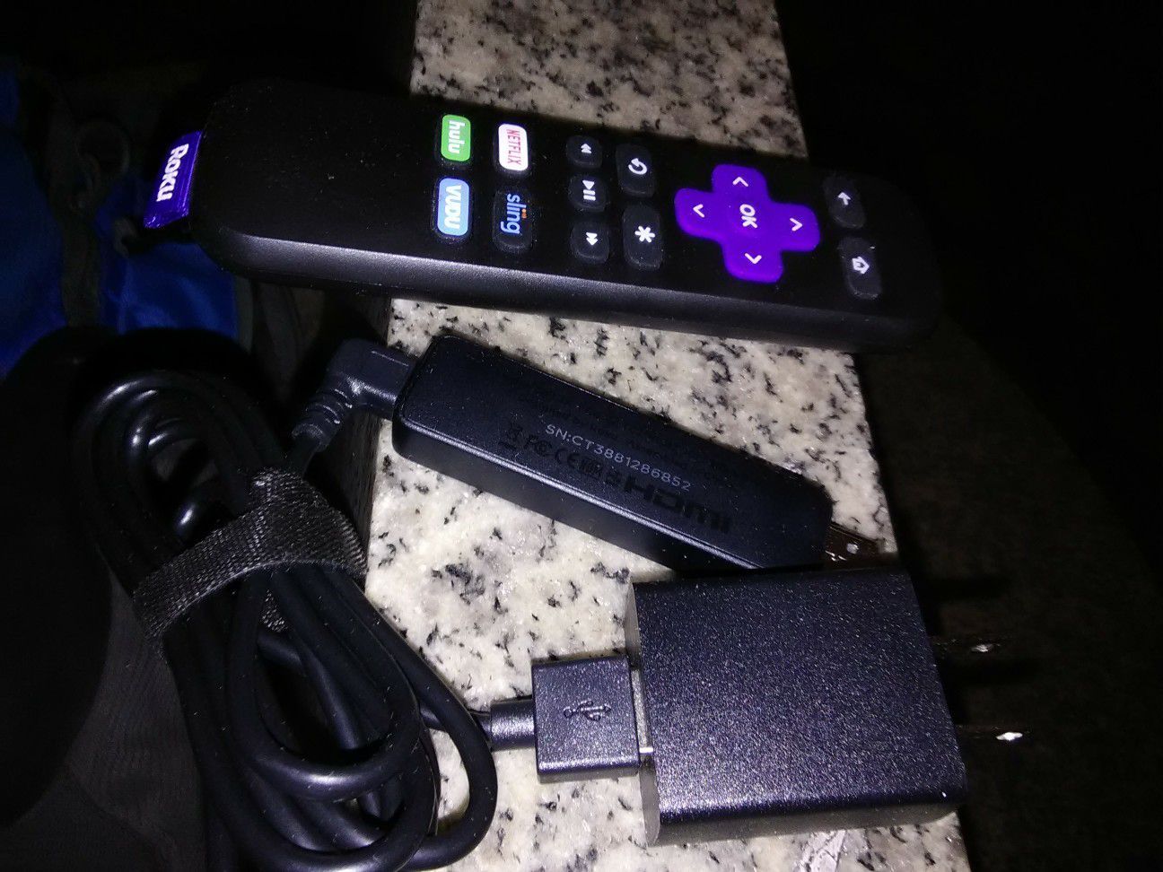 Roku streaming stick with charger cable and remote control