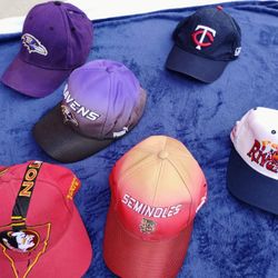 MANY NEW/LIKE NEW SPORTS TEAM BALL CAPS. WILL SELL AS LOT OR INDIVIDUALLY 