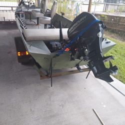 15 Ft. Alumacraft Jon Boat With A 20 HP Mercury 4 Stroke  Outboard Motor 