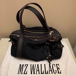 MZ WALLACE NYLON PURSE. Lots of compartments  Leather straps. Measurements 17x10x6 Pre owned in great condition. Dark blue color. Comes with the dust 