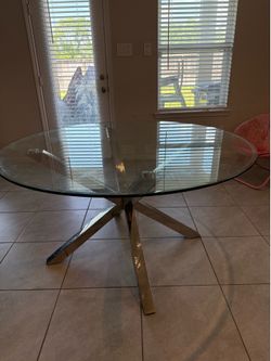 Glass top dining table with silver base