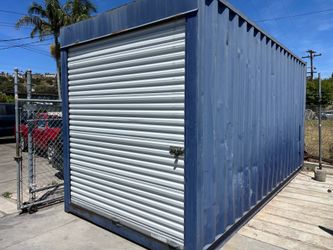 Storage container with roll up door