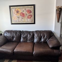 Two leathers sofas with love sit  and area rug. 