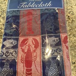 Windham Weavers brand, 100% cotton, 52-inch square tablecloth features a nautical design with red lobsters and blue fish