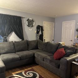 2 Piece sectional with 6 spots with a built in chaise and a swivel chair and ottoman.