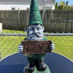 Gnome holding go away sign