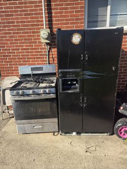 Black Side-by-Side Refrigerator and Gas Range Set