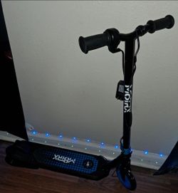 M8TRX Sports) electric scooter.  
​These are 12V electric scooters typically designed for children aged 6–12 years, featuring a thumb-activated thrott