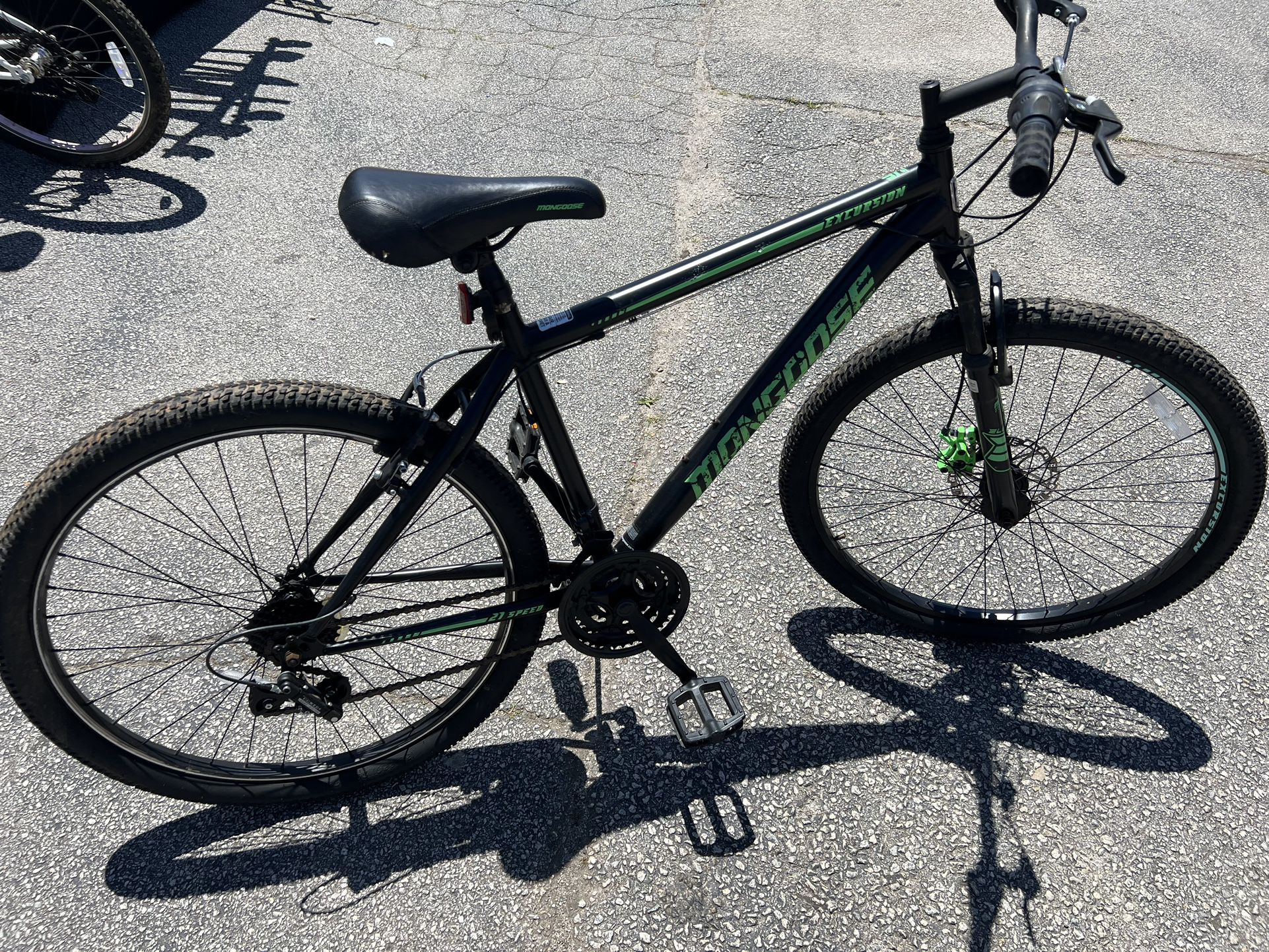 Mongoose Excursion mountain bike, 26 inch wheel, 21 speeds, mens frame, black / green