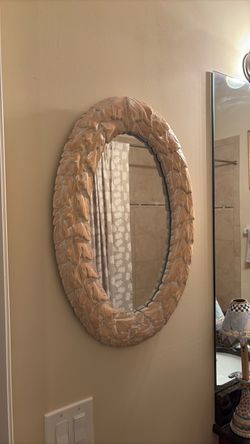 Carved wood oval mirror