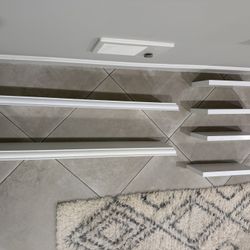 Selling two sets of white floating shelves — great for books, décor, or plants.