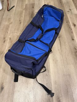 Bag Boy golf travel bag with wheels on the bottom.