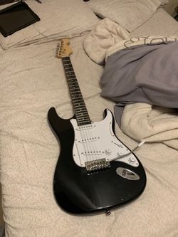 ELECTRIC GUITAR with spare strings (no pick or amp)