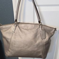 This is a metallic silver Coach Kelsey Satchel