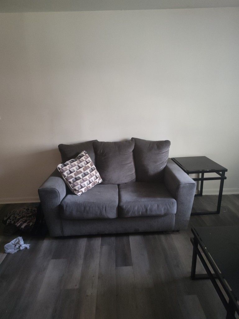 Grey Love Seat And Grey Couch With 2 End Tables And Table