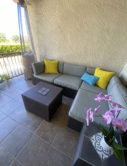 Patio sectional with coffee table and ottoman.