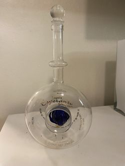 Esperanto tequila bottle clear bottle. Gorgeous for any bar with a blue glass flower at the center.