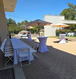 Table, chairs, fringe umbrellas, cocktail tables