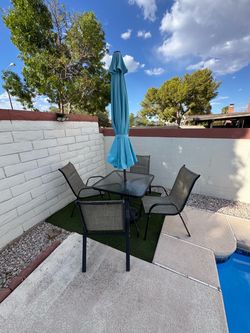 Patio table with umbrella and 4 chairs in $80