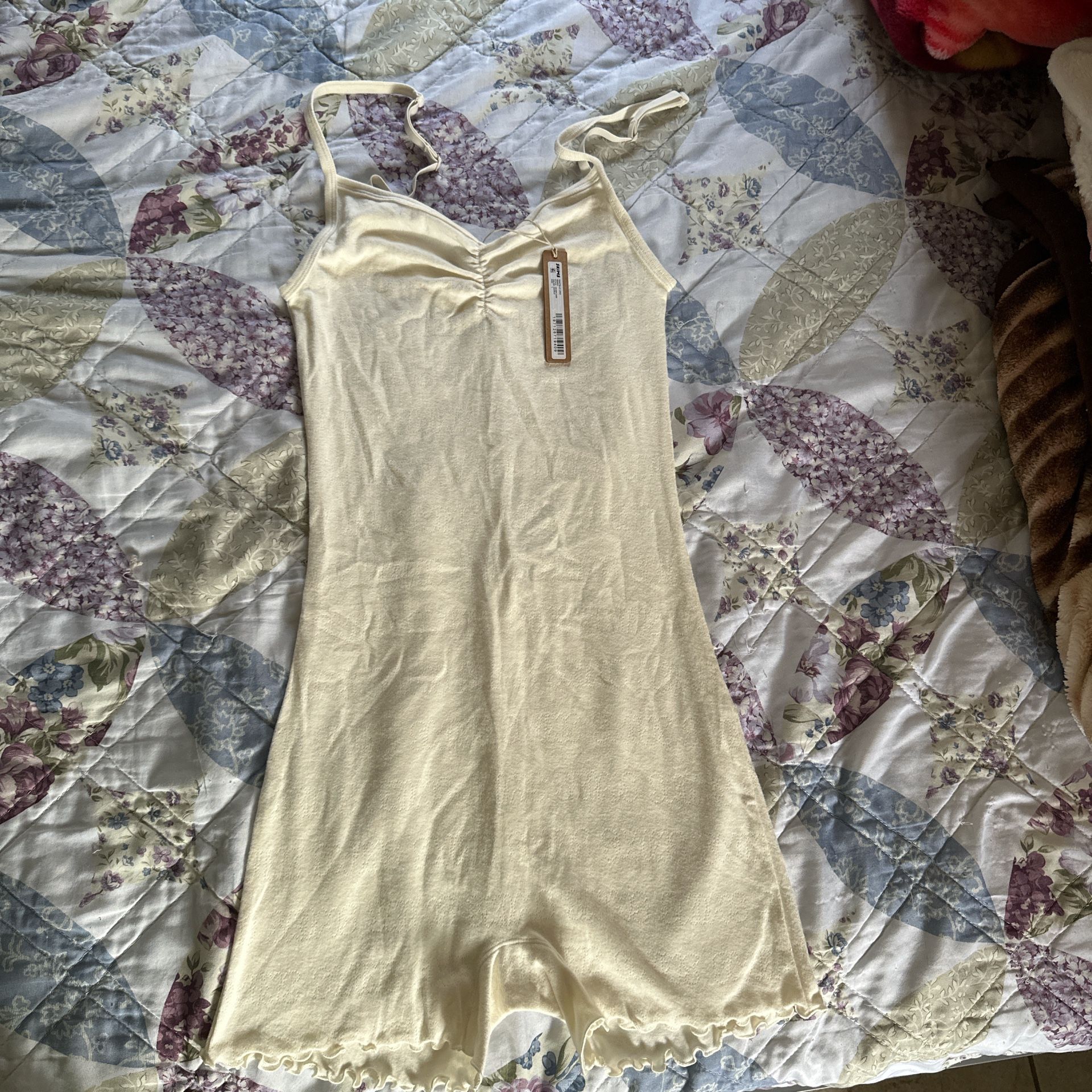 skims logo pointelle onesie in white,