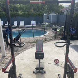 Squat Rack With Bench, Dip Handle Bars, And Weight Holders 