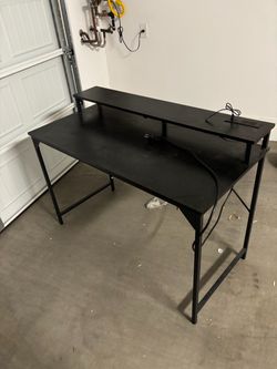 Black desk with charger and plug options
