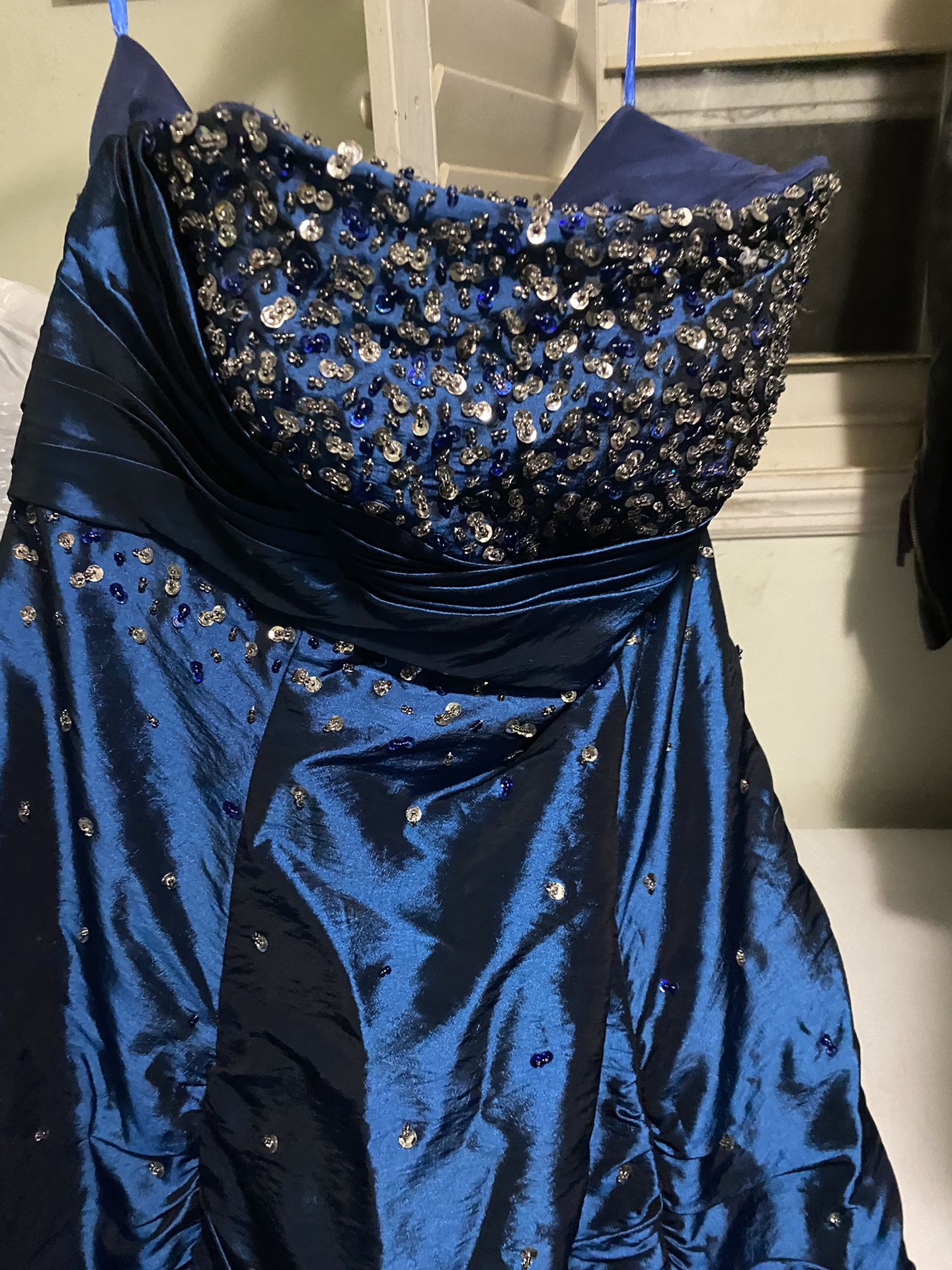 Fairytale gown, Saphire Blue, And It Doesn’t Have A Size But My Guess Is 