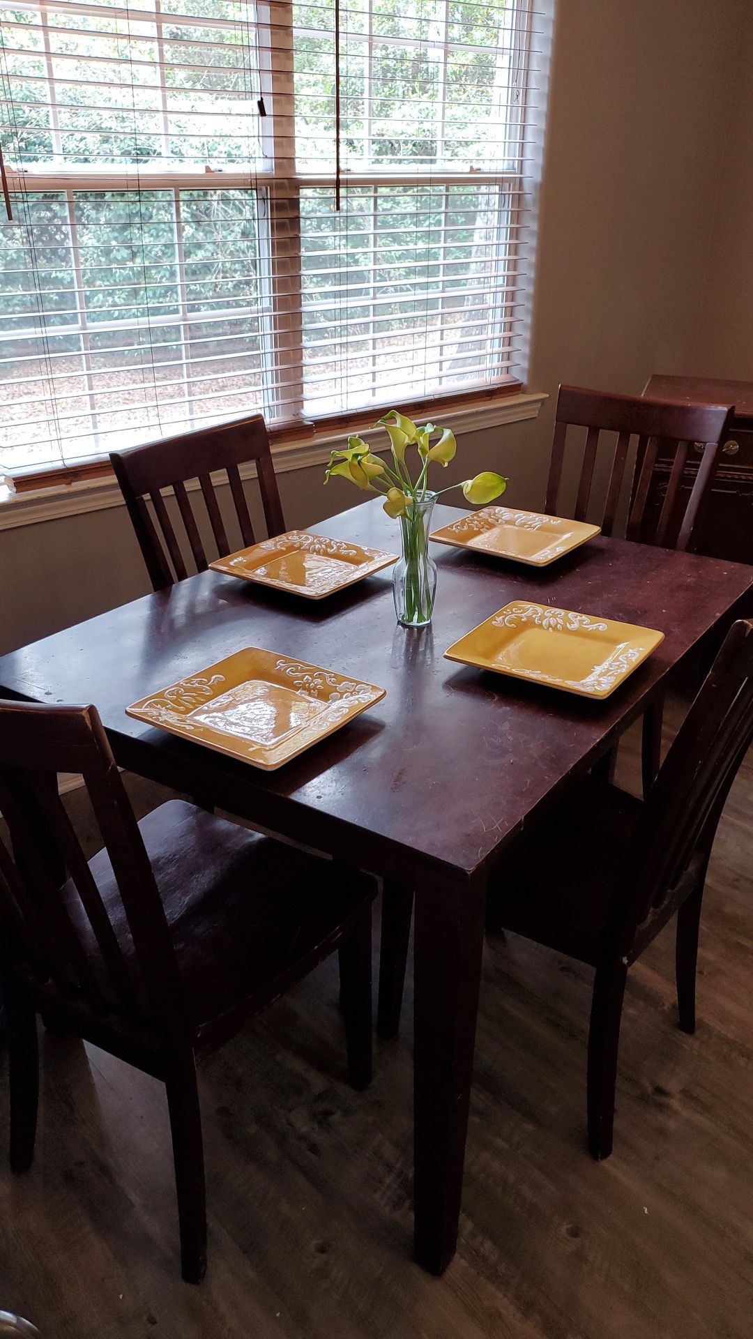 Dark wood dining room table with matching four chairs
