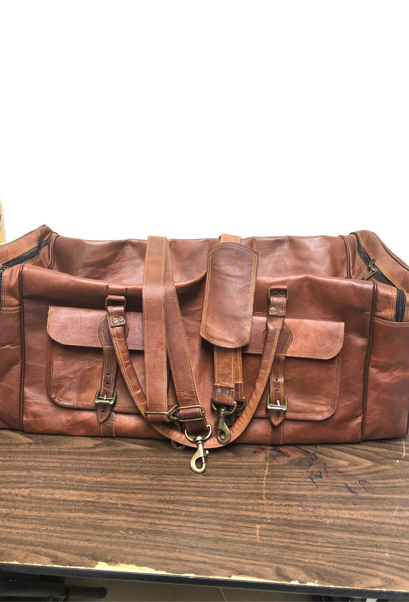 Offering brown large leather duffle bag