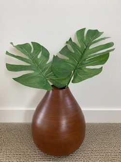 Bamboo vase with palm leaf