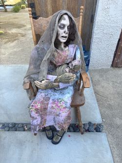 Scary, rocking chair lady with baby Halloween decoration