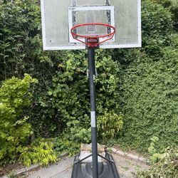 Adjustable basketball hoop. Glass protective shield still on. 