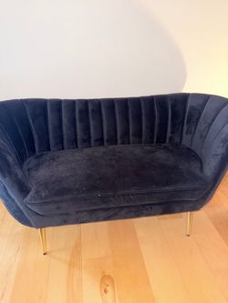 Black couch with gold legs